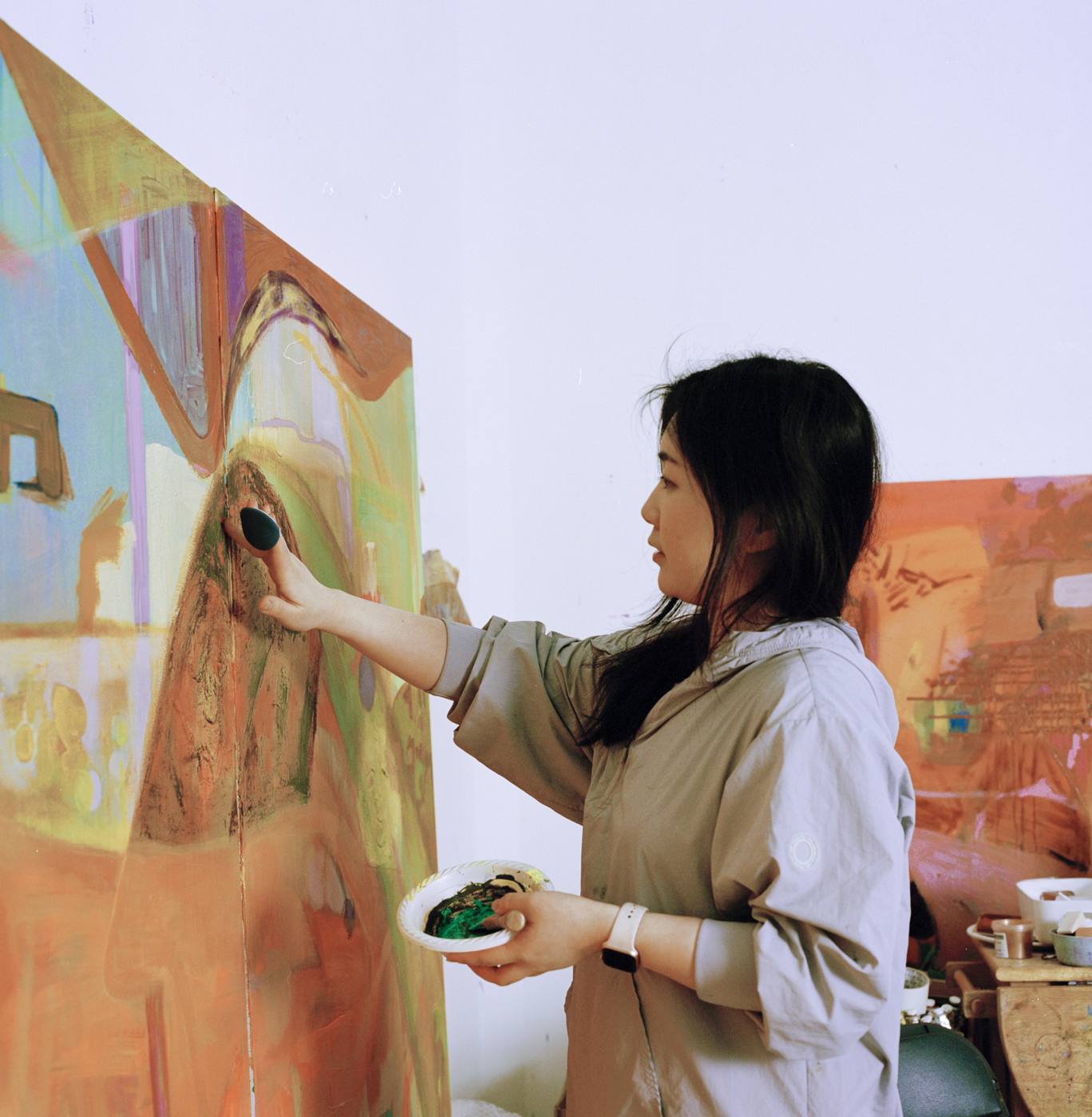Dina Jin Bae painting in her studio